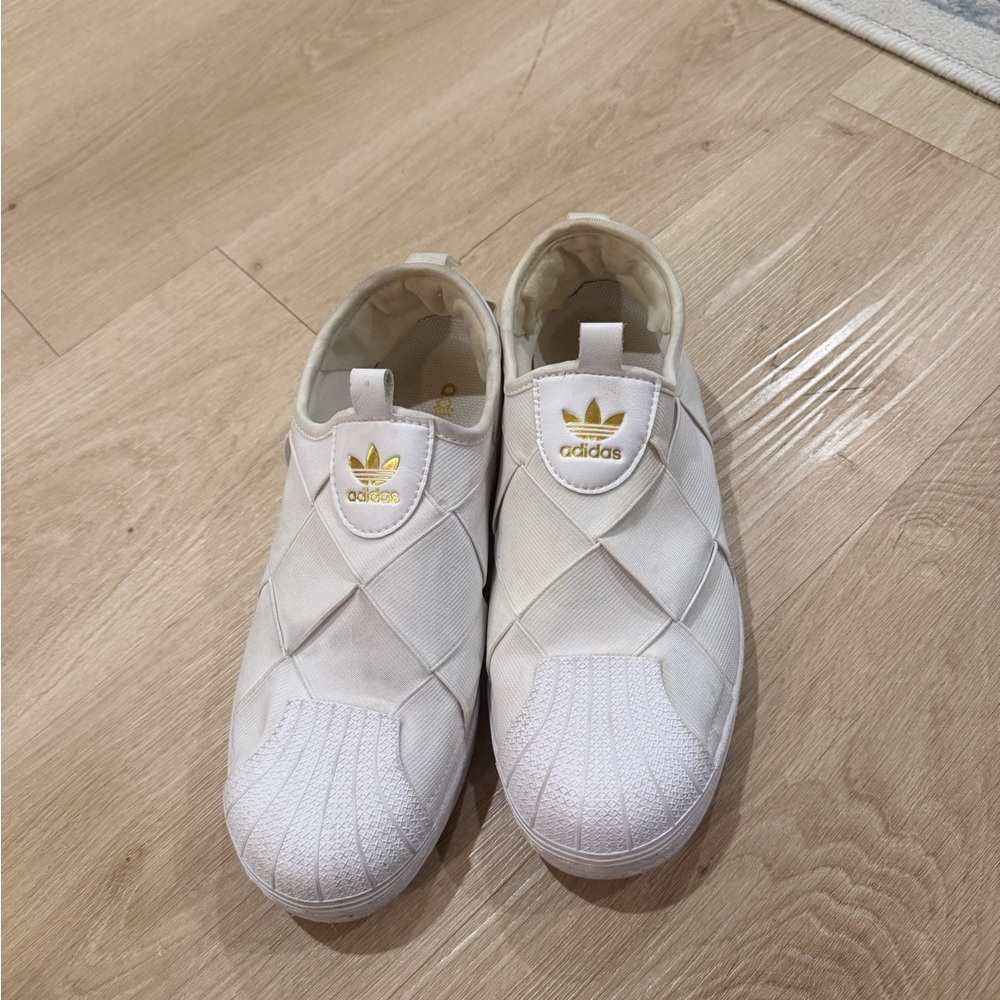 Adidas Quilted White Slip-Ons with Gold Accents